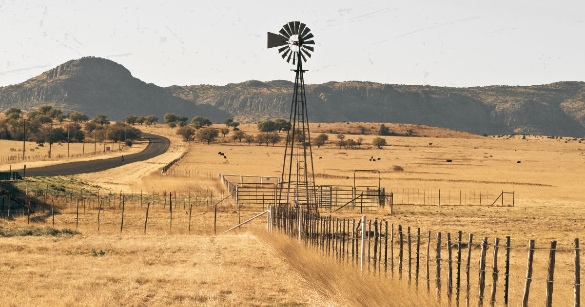 A windmill in the middle of a field.